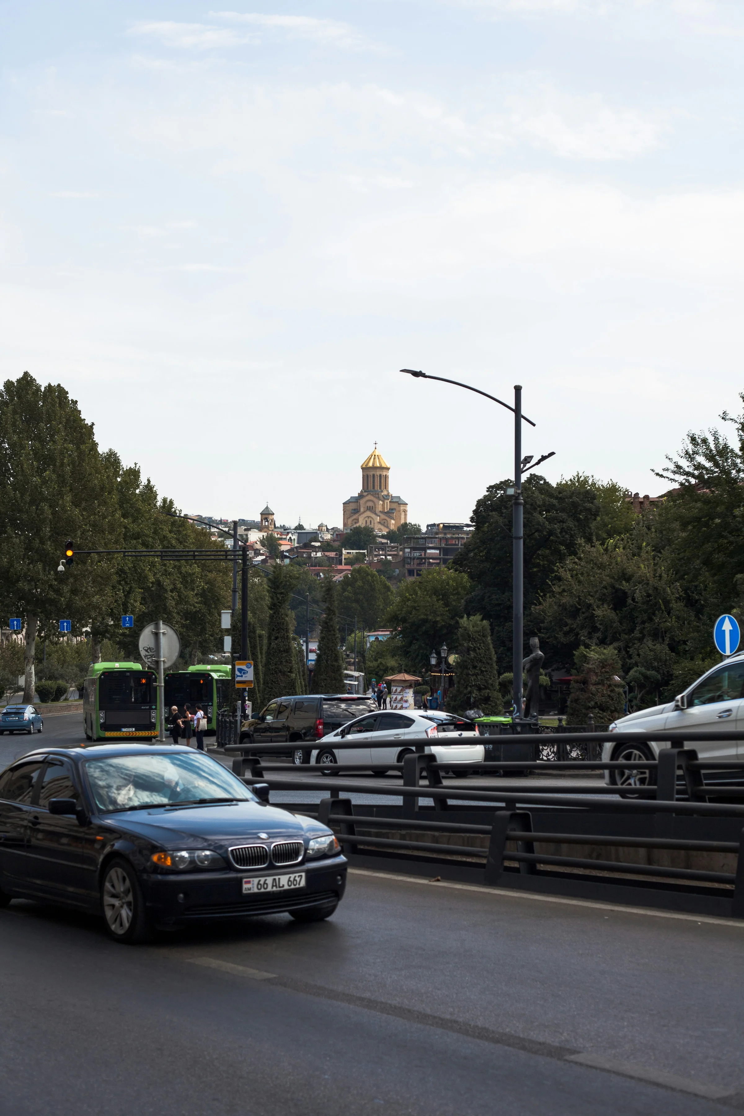 BMW driving on a Tbilisi road with Holy Trinity Cathedral in the background