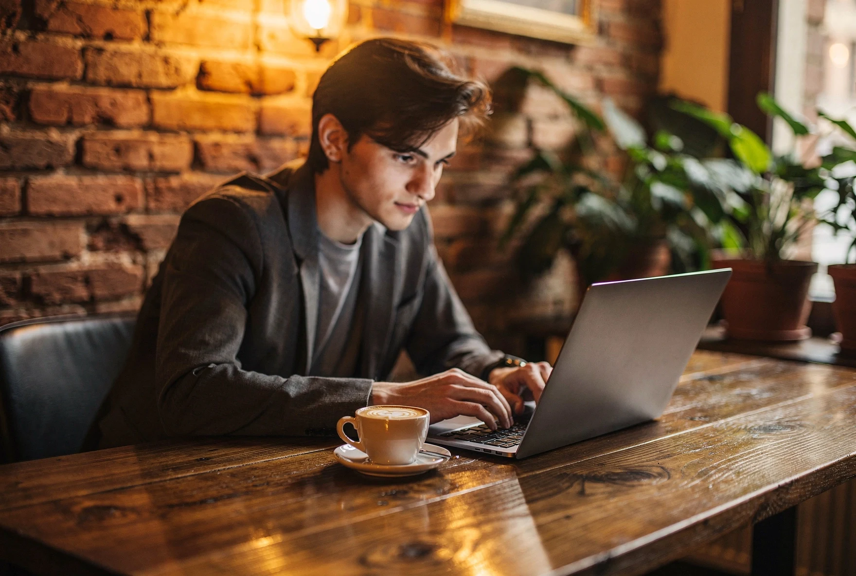 Person working at a cozy Tbilisi café with specialty coffee