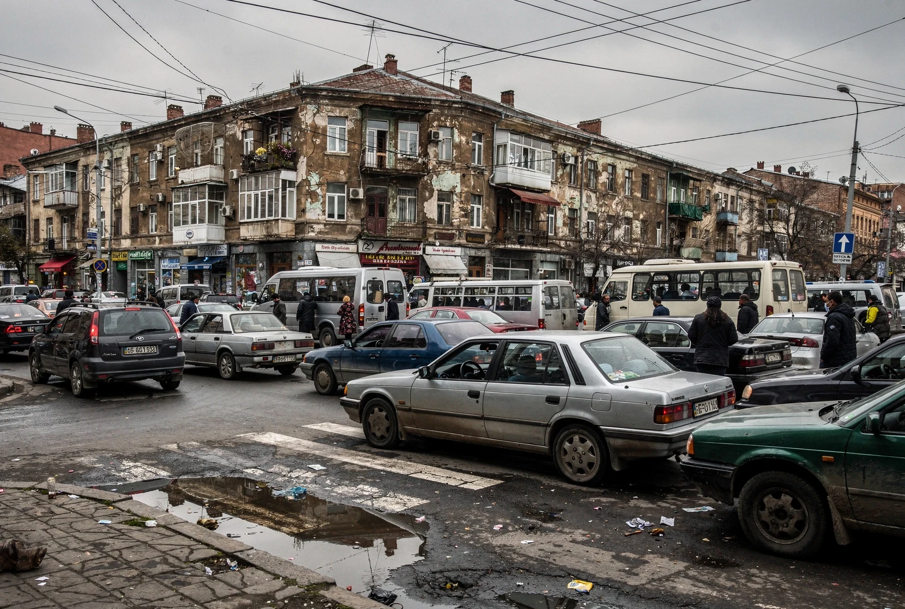 Busy Tbilisi intersection with traffic congestion and chaotic parking