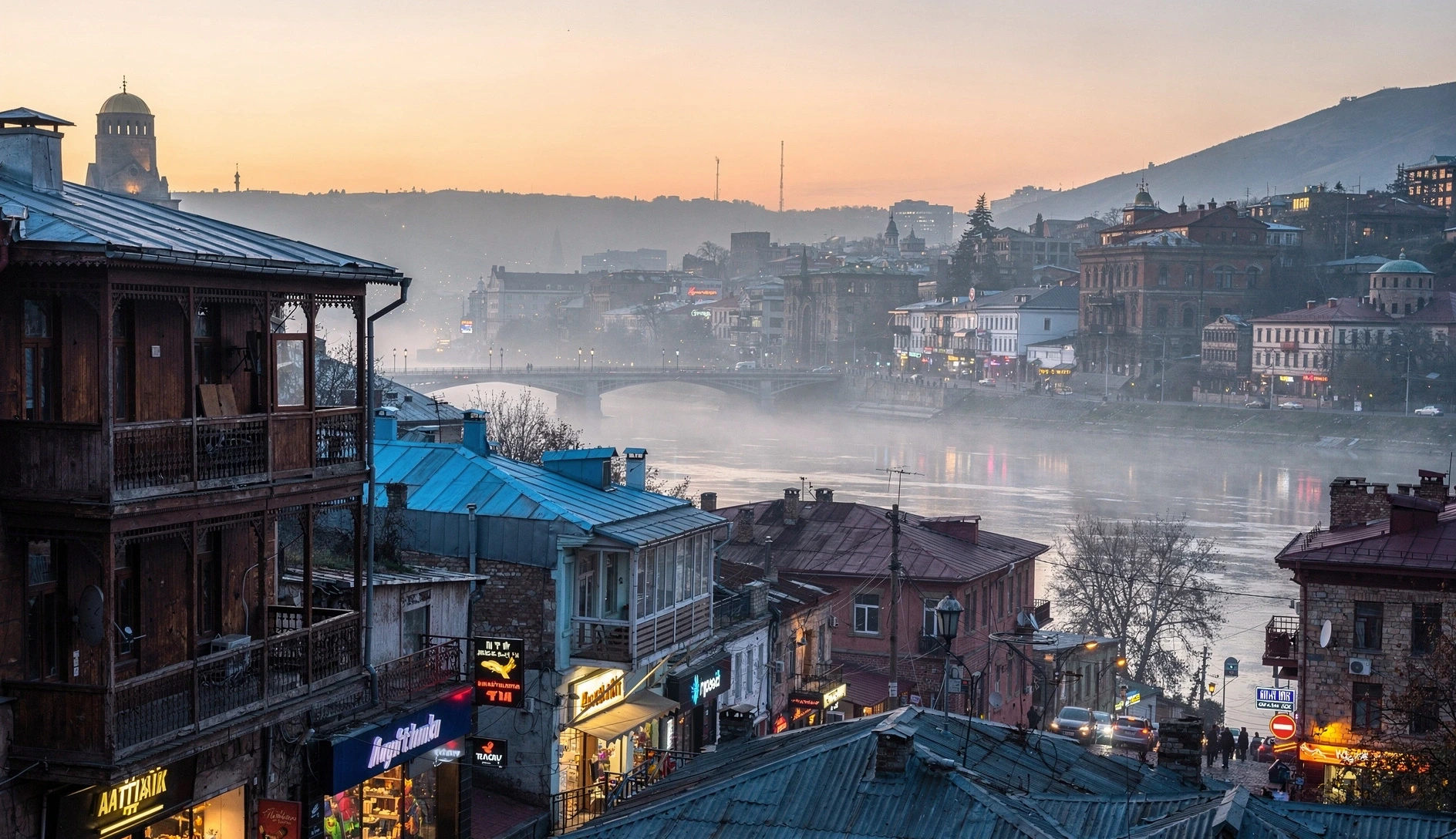 Tbilisi old town at dawn with morning haze and mist over the Mtkvari river
