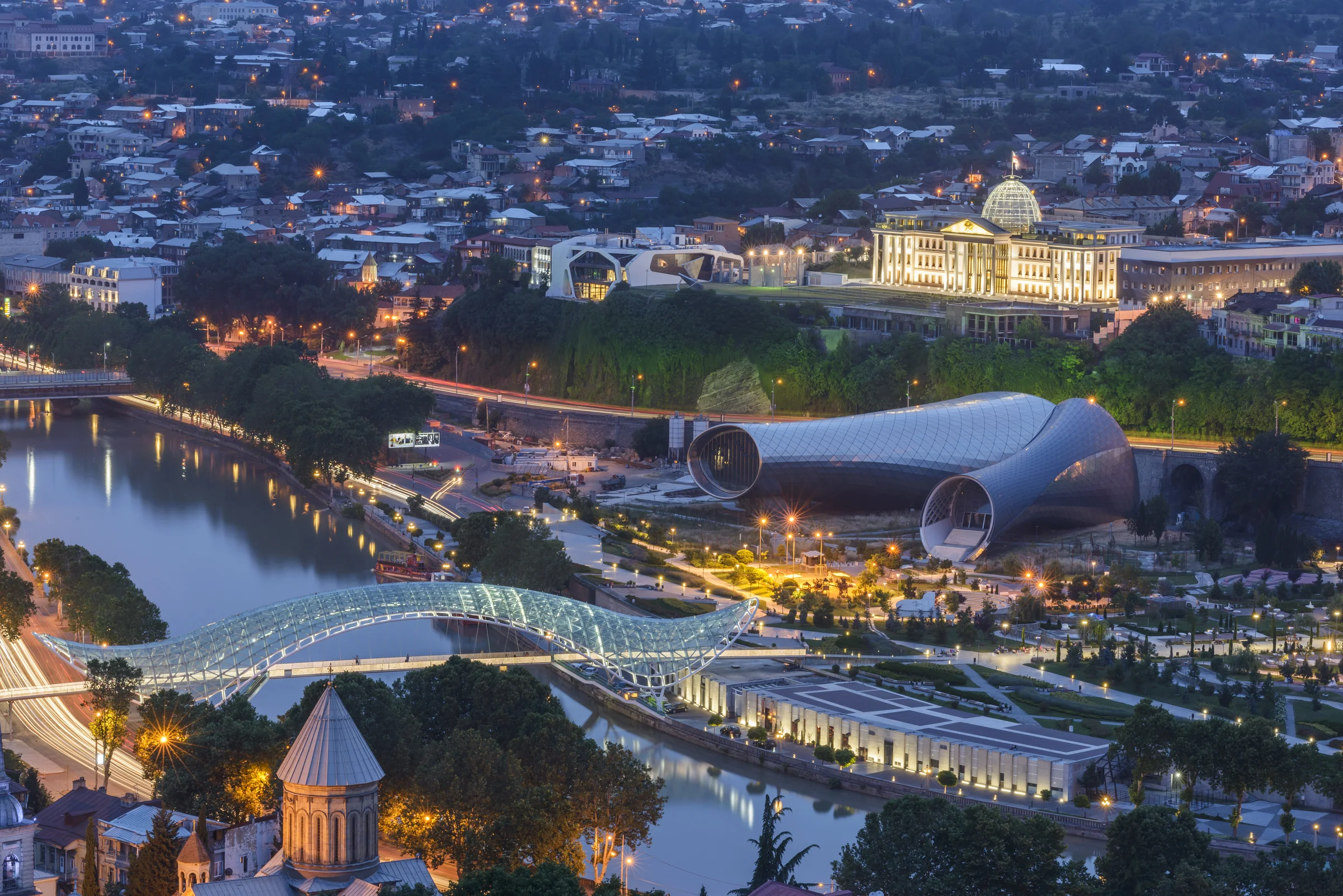 Panoramic twilight view of Tbilisi with the Bridge of Peace and old town
