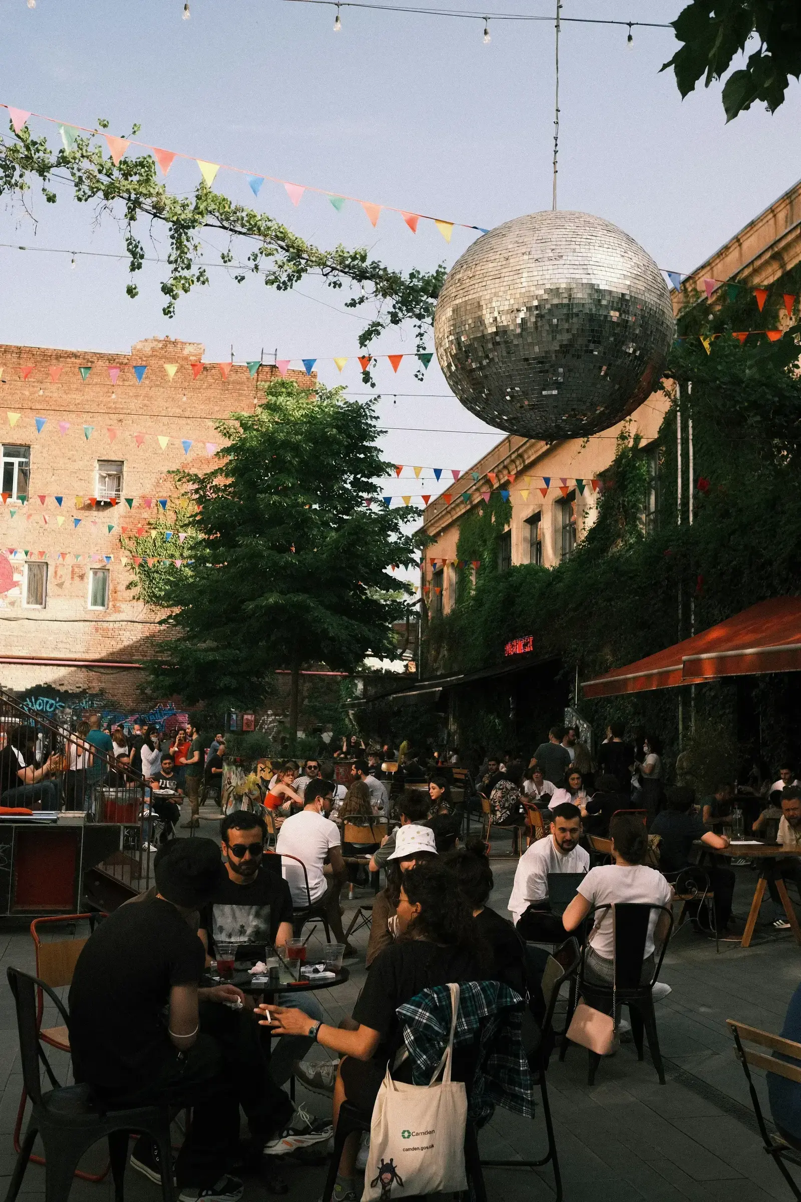 Fabrika courtyard in Tbilisi with people socializing under string lights