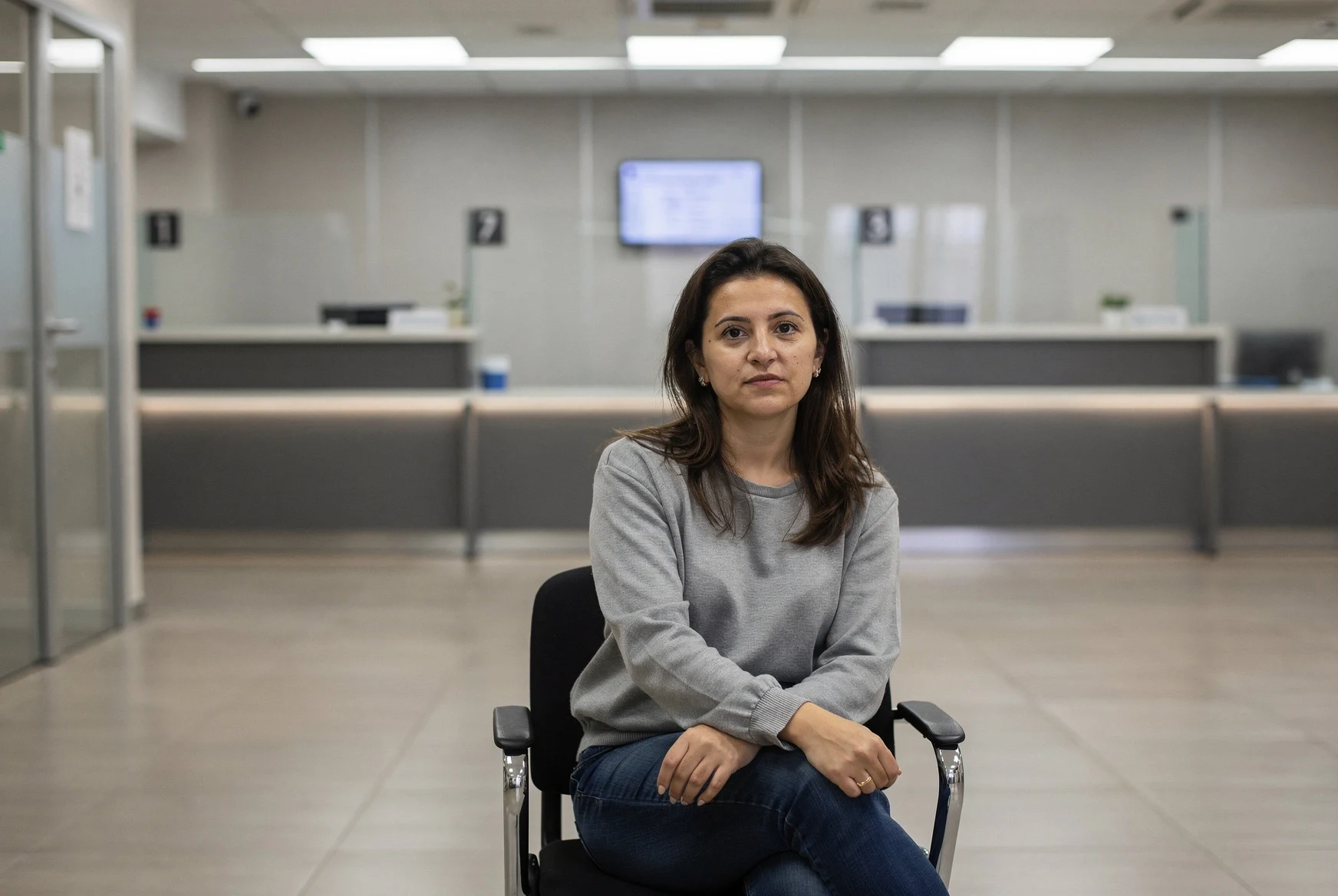 Expat waiting in a modern government service hall in Tbilisi