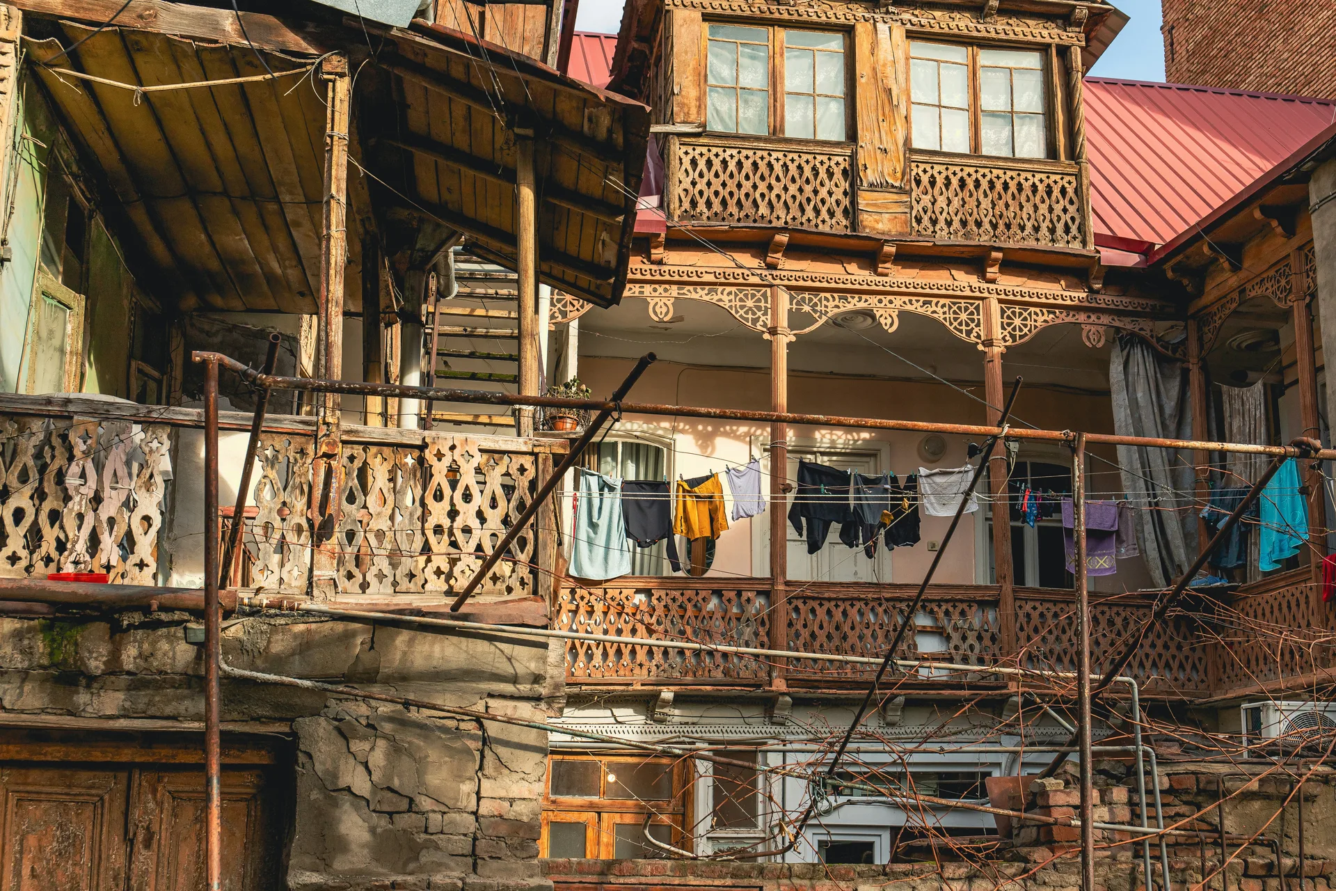 Traditional Tbilisi courtyard with multi-level wooden balconies and ornate carvings